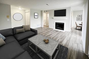 a living room with a couch and a coffee table and a fireplace at Deercross Apartments, Cincinnati, Ohio